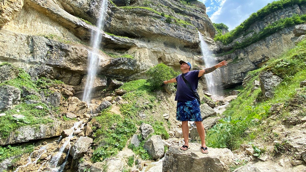 Man in Azerbaijan near waterfall