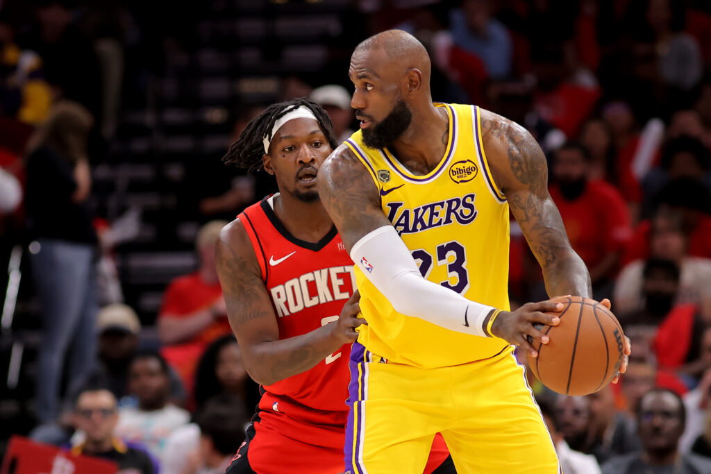 May 1, 2026; Houston, Texas, USA; Los Angeles Lakers forward Lebron James (23) handles the ball against Houston Rockets forward Dorian Finney-Smith (2) during the second quarter of game six of the first round of the 2026 NBA Playoffs at Toyota Center. Mandatory Credit: Erik Williams-Imagn Images
