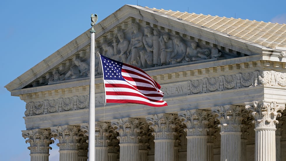 FILE - An American flag waves in front of the Supreme Court building on Capitol Hill in...