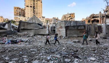 People walk outside a residential building that was hit by an Israeli strike the previous day in the Rimal neighbourhood of Gaza City on May 16, 2026. Israel said on May 15 that it carried out a strike in Gaza targeting Ezzedine Al-Haddad, who described it as chief of the armed wing of Palestinian movement Hamas. Since Hamas's Oct. 7, 2023 attack on Israel, the Israeli military and intelligence services have waged an extensive campaign targeting the group's senior political leaders and militant commanders in Gaza and across the region.