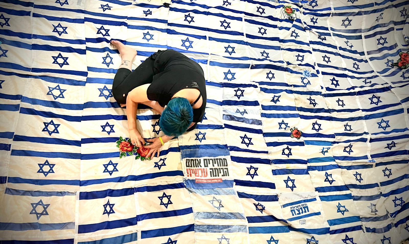 Using discarded Israeli flags, artist tries to stitch divided country together