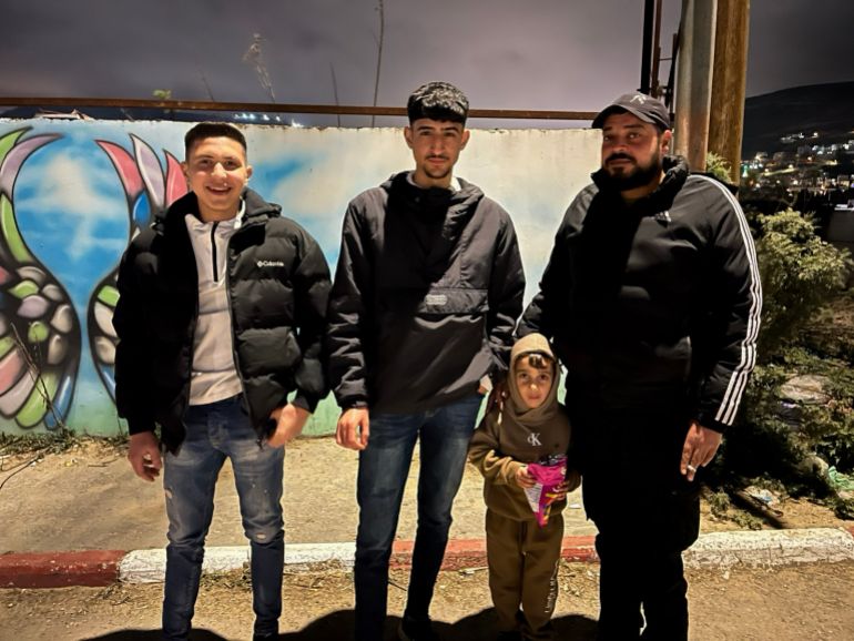 Three young people stand up