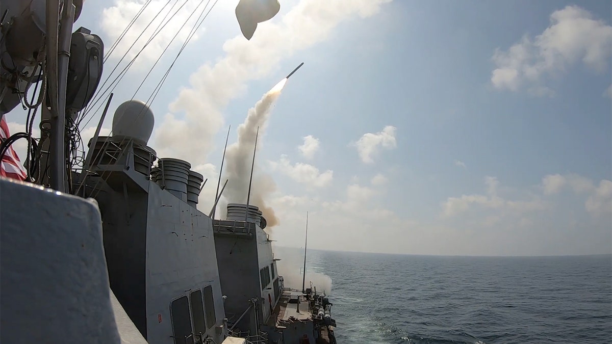 A U.S. Navy ship launching Tomahawk Land Attack Missiles at sea