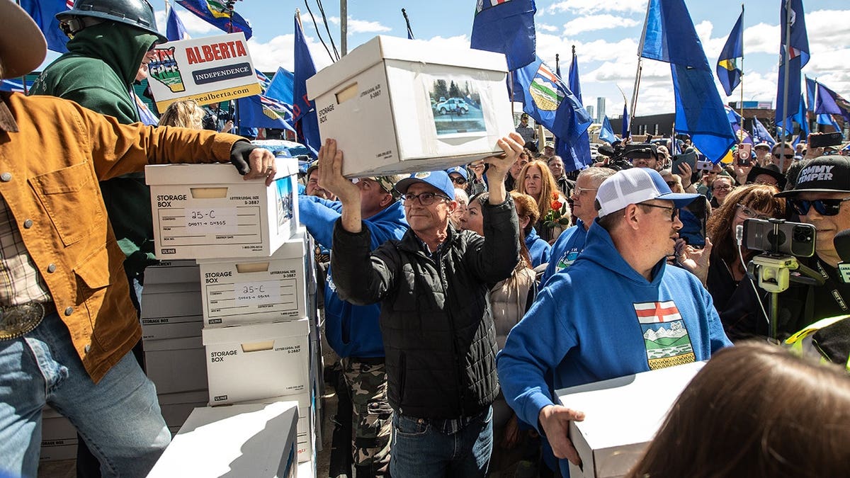 Supporters carrying boxes of signatures outside Elections Alberta building in Edmonton