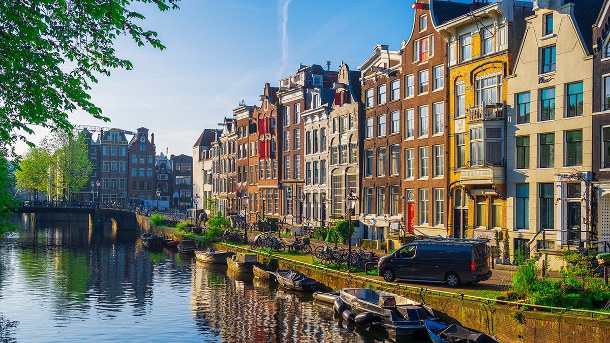 Canal houses and boats on the canal in downtown Amsterdam