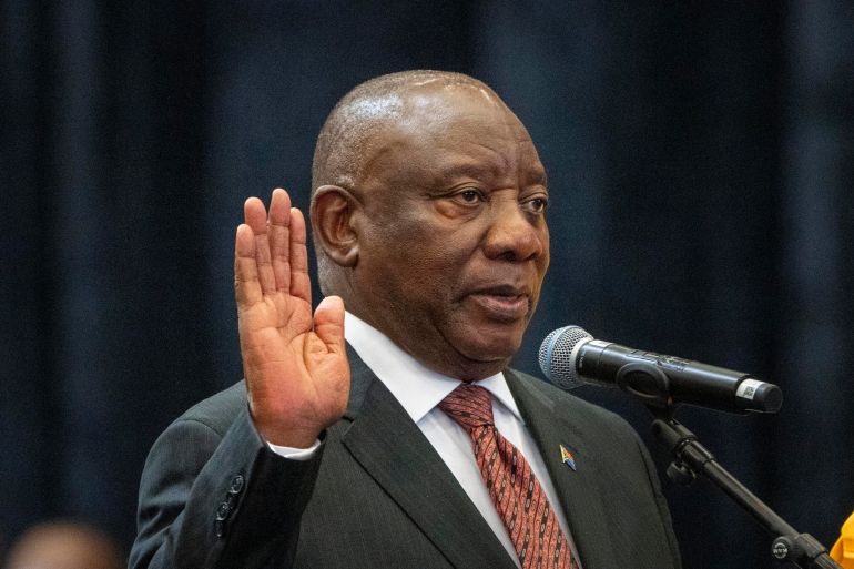 FILE - South African President Cyril Ramaphosa raises his hand as he is sworn is as a member of Parliament ahead of an expected vote by lawmakers to decide if he is reelected as leader of the country in Cape Town, South Africa, June 14, 2024. (AP Photo/Jerome Delay, file)