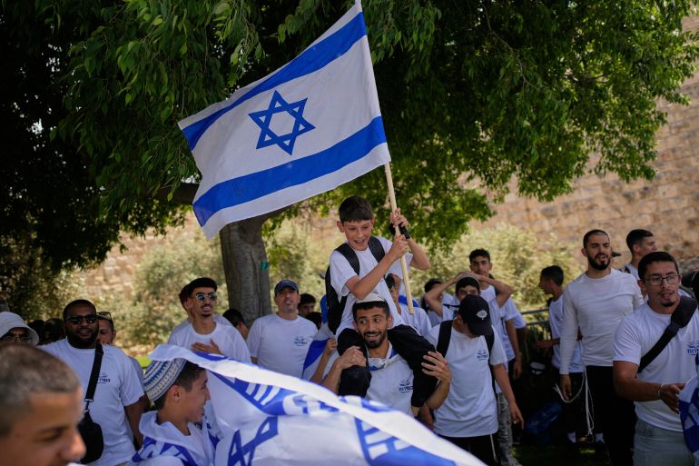 Israeli youth carrying Israeli flags gather outside Jerusalem's Old City walls before a march marking Jerusalem Day, an Israeli holiday celebrating the capture of east Jerusalem in the 1967 Mideast war, in Jerusalem, Thursday, May 14, 2026. (AP Photo/Ohad Zwigenberg)