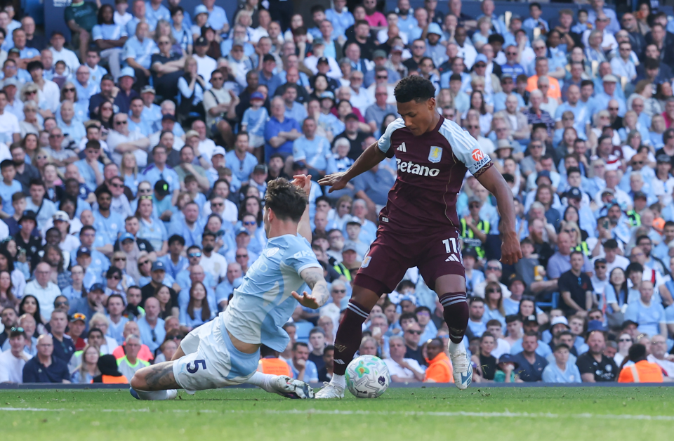 Ollie Watkins dribbles past John Stones