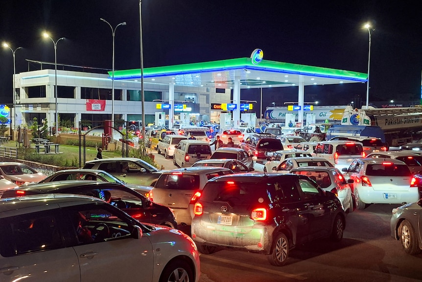 cars line up outside a fuel station 