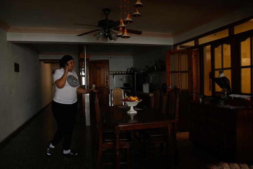 a woman talks on the phone during a blackout 