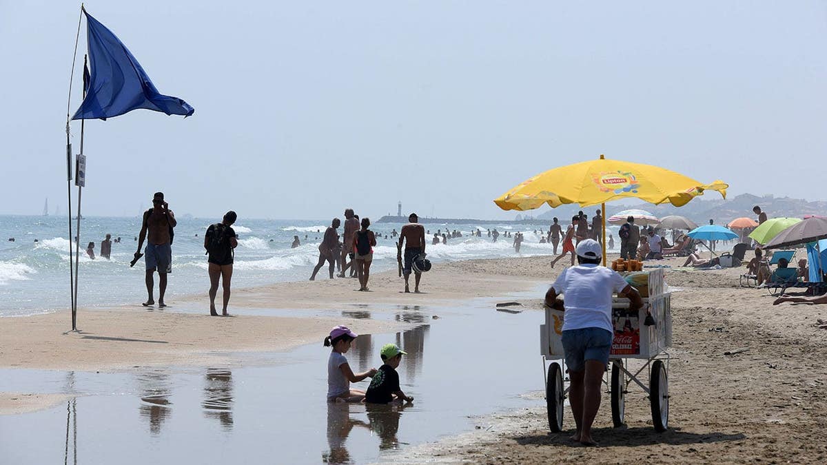 Blue flags marking the start of the nudist beach at Cap d'Agde on the Mediterranean coast