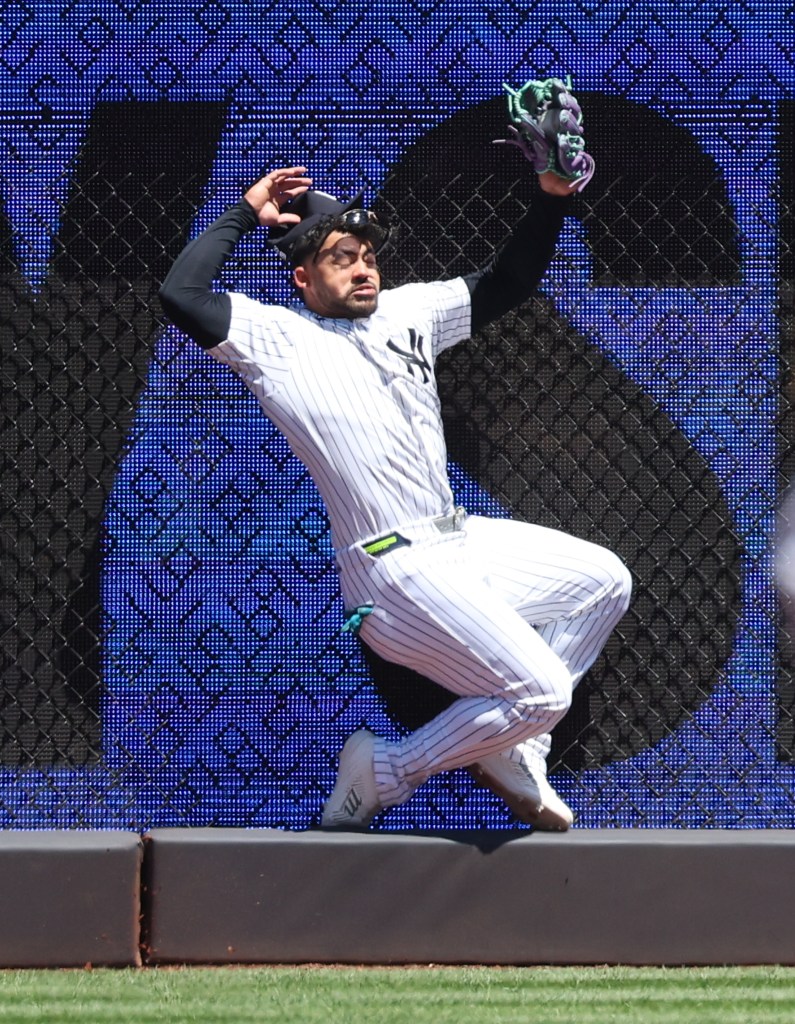 Yankees outfielder Jasson Dominguez crashes into the wall making a catch in the first inning on May 7, 2026.