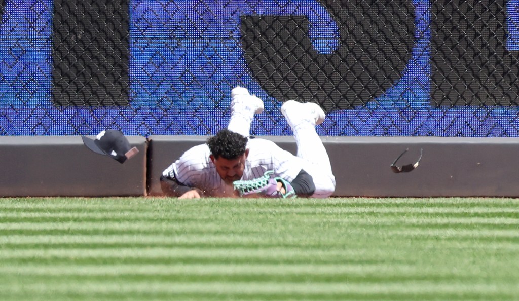 Yankees outfielder Jasson Dominguez down on the ground after crashing into the wall making a catch in the first inning on May 7, 2026.