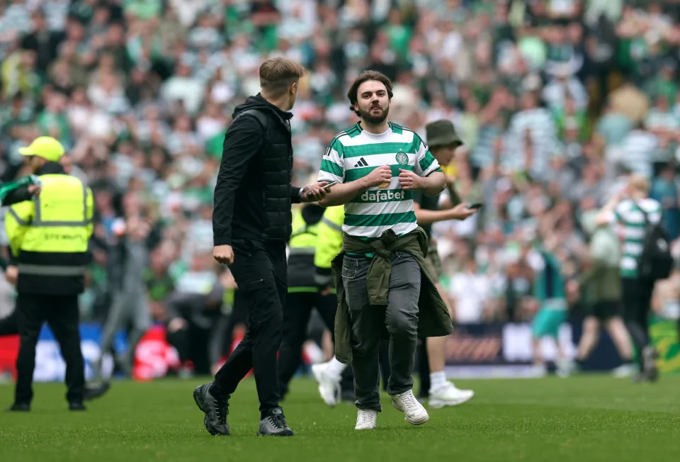 Celtic fans invade the pitch during the William Hill Premiership match between Celtic and Heart of Midlothian