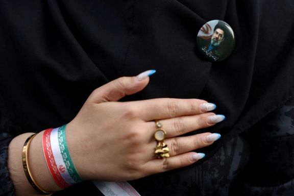 A woman wears a badge with a picture of Iran’s new Supreme Leader, Mojtaba Khamenei, during a rally in Tehran, Iran, April 29, 2026.