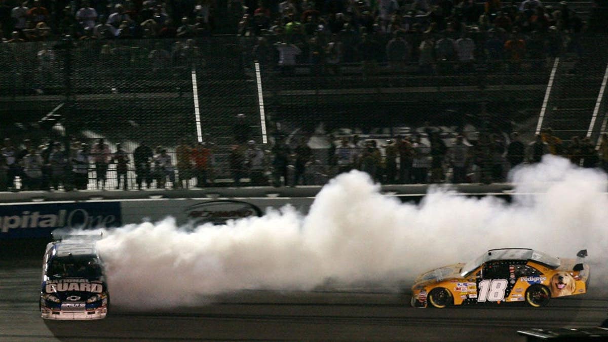 Dale Earnhardt Jr. spinning out of control after colliding with Kyle Busch during a NASCAR race