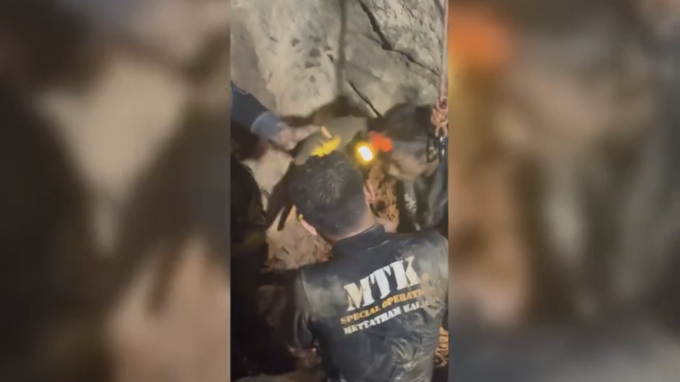 Rescuers evacuate the first of 5 villagers found trapped in a cave in Laos; 2 still missing
