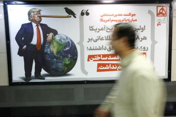 People walk past a caricature depicting US President Donald Trump, in Tehran, Iran, May 4, 2026.