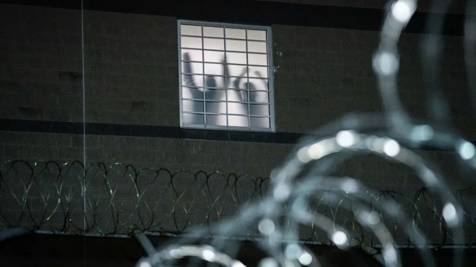 Detainees stand by a window inside the federal immigration center at Delaney Hall in Newark, where ICE is housing detained immigrants on May 26, 2026 in Newark, New Jersey. T - Adam Gray/Getty Images