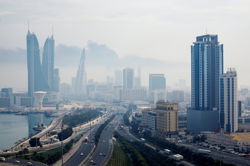 The Bahrain skyline is seen clouded with grey smoke.