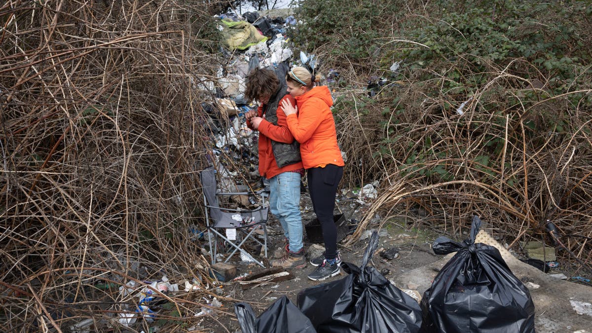 Andrea Suarez talks to a homeless man injecting methamphetamine in Seattle