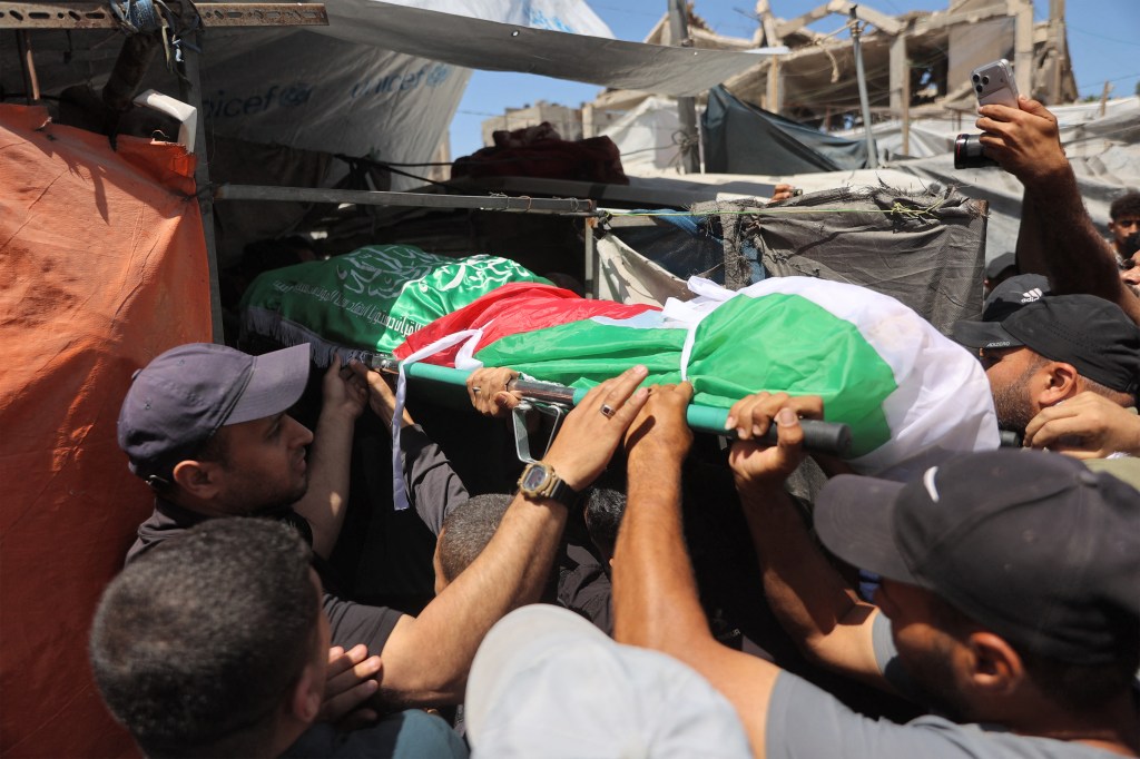 Mourners carrying the body of Ezzedine Al-Haddad during his funeral in Gaza City.