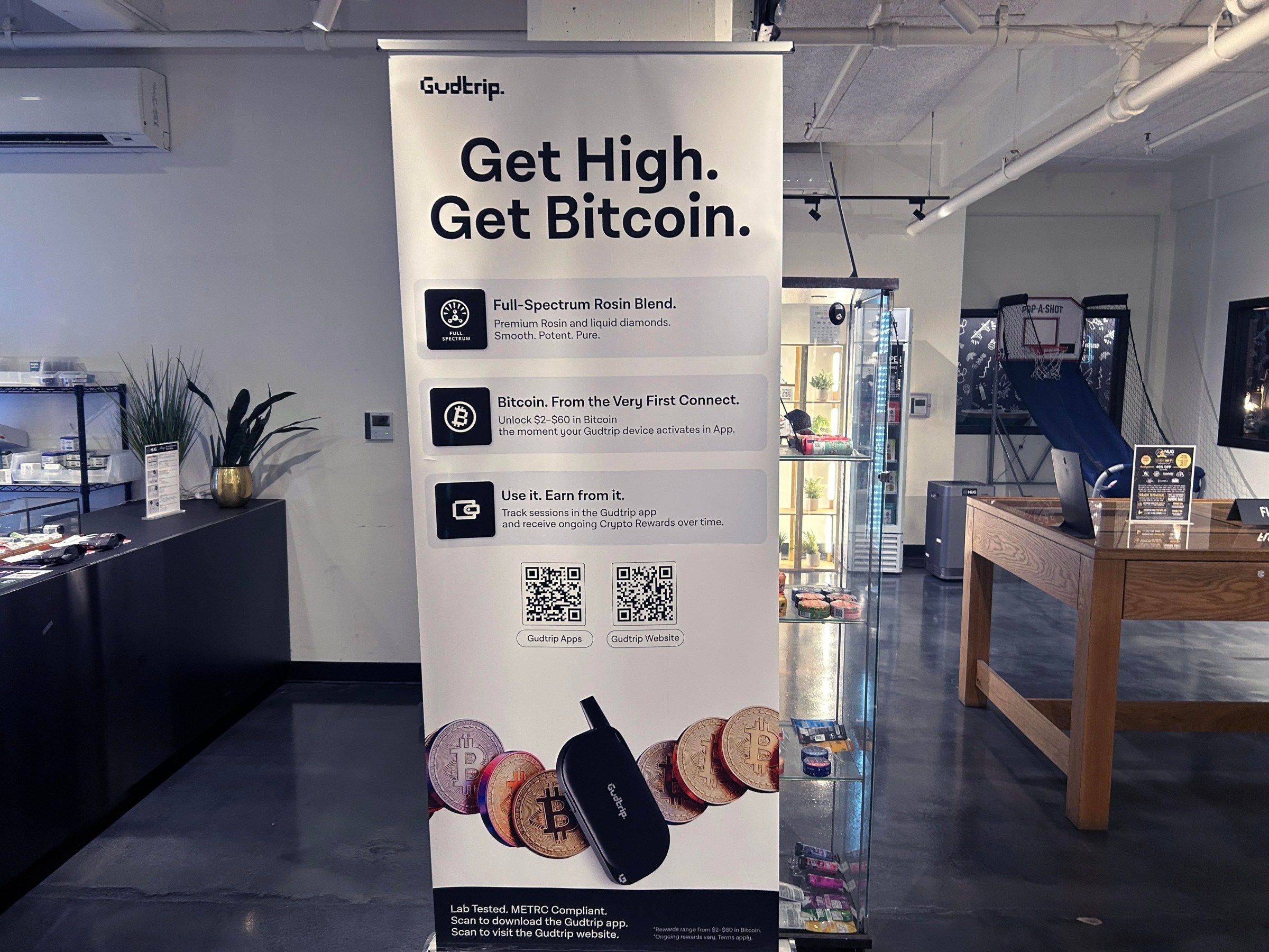 A Gudtrip poster in NUG Cannabis Dispensary in Oakland, California.