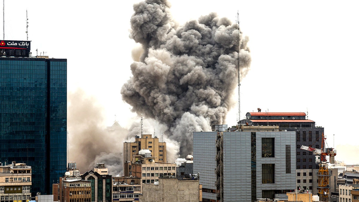 A general view of Tehran with smoke rising in the distance after explosions