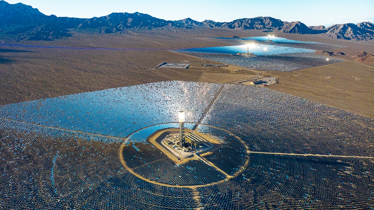 Aerial view of Ivanpah solar plant with mirrors and central tower in desert