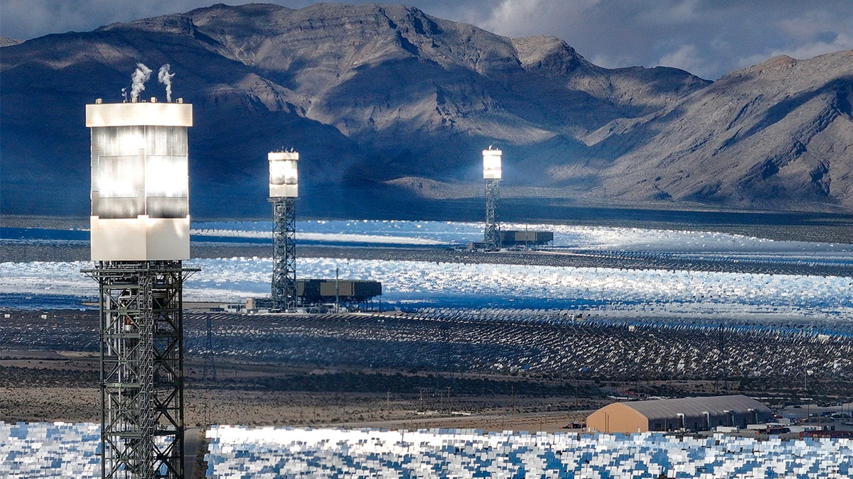 Ivanpah solar plant towers reflecting sunlight in California desert