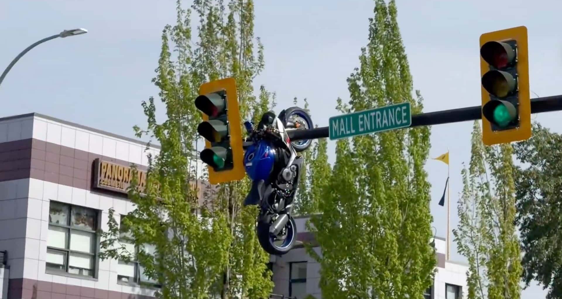 A Driver Turned And Couldn't See. Then A Motorcyce Ended Up Dangling From A Traffic Light Pole