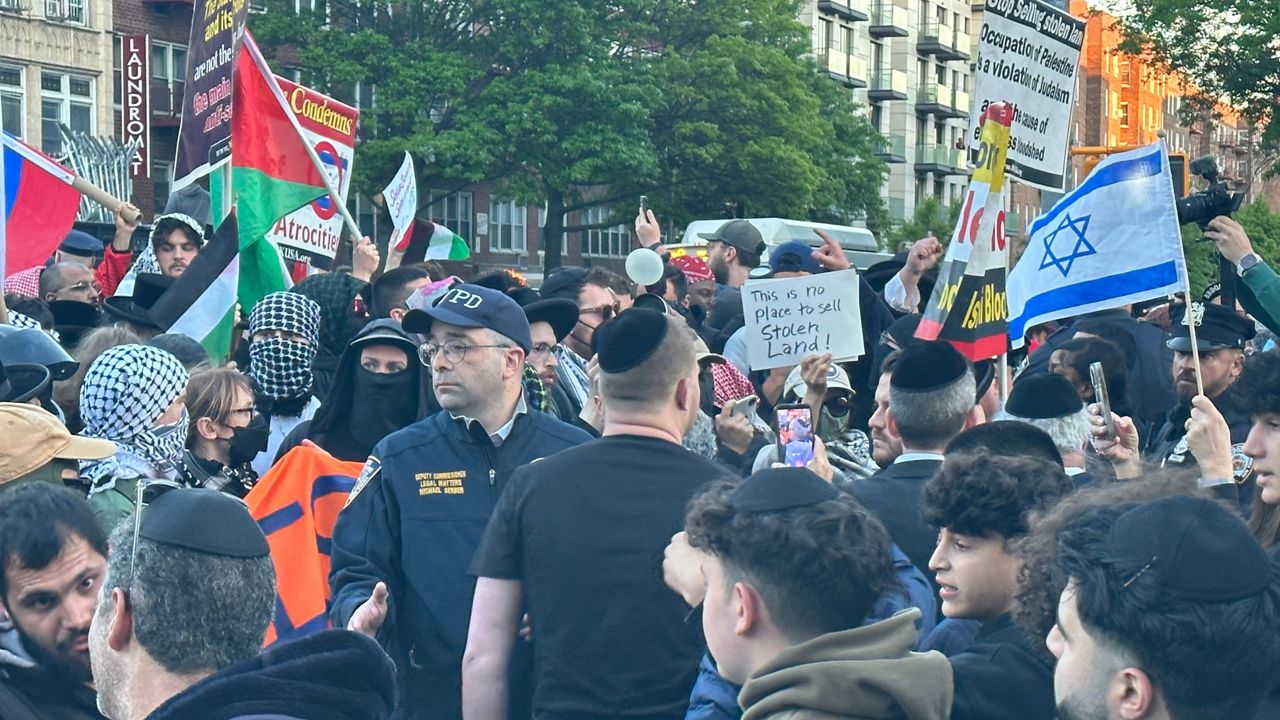 Police lined the area as hundreds came out on both sides of the issue of land sales in the Middle East. (Spectrum News NY1/Louis Finley)