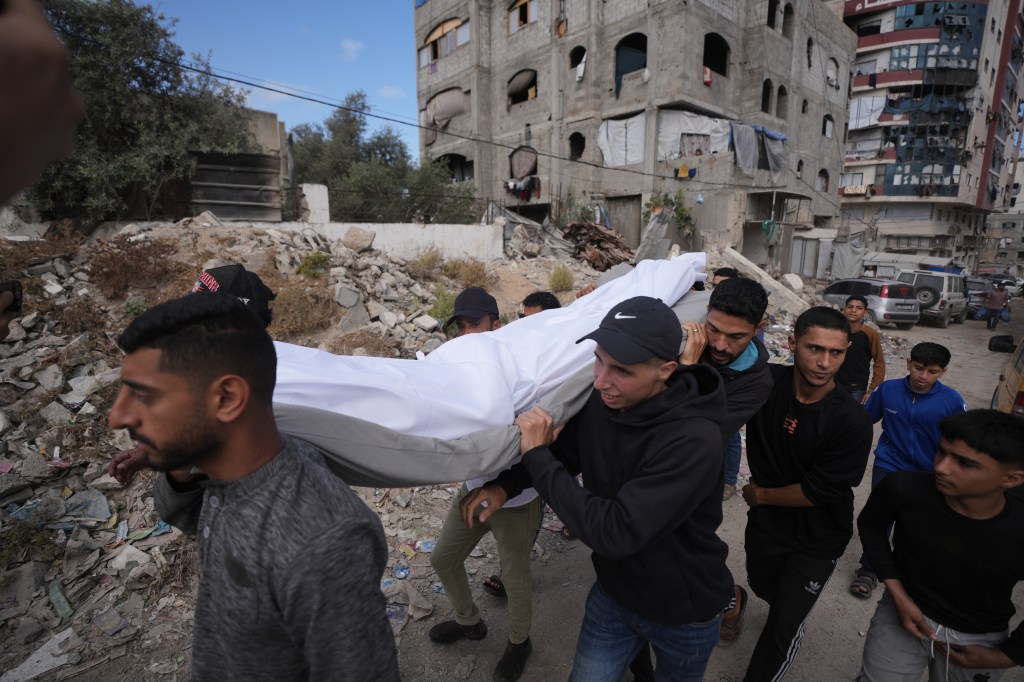 Palestinians carrying the body of a person killed in Israeli airstrikes for a funeral in Gaza City.