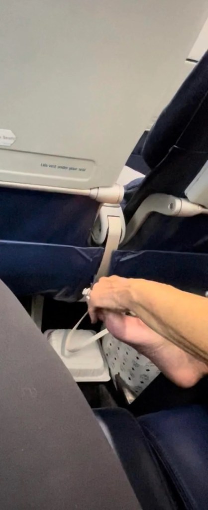 Woman picking feet on flight.