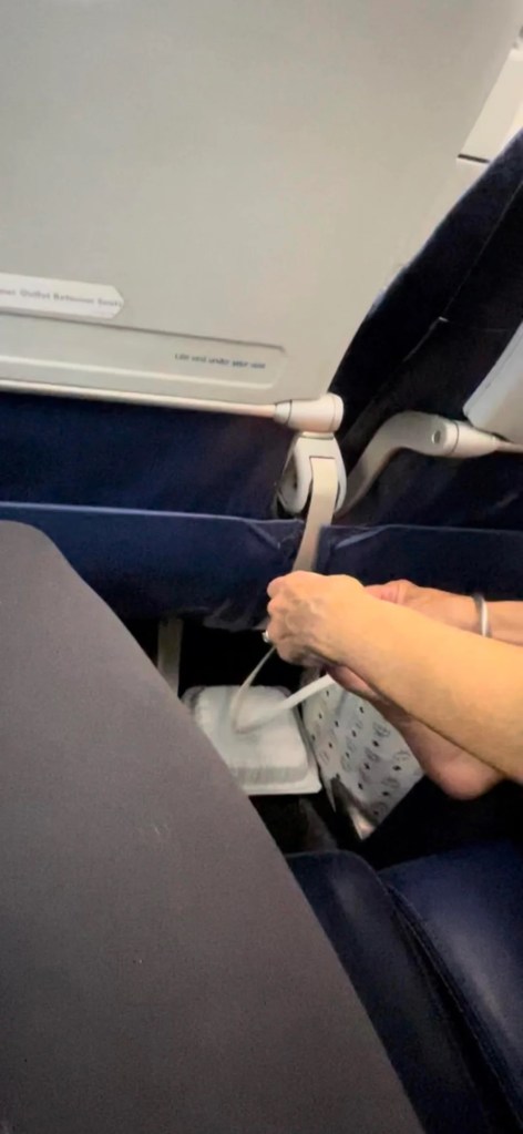 Person picking feet on flight.