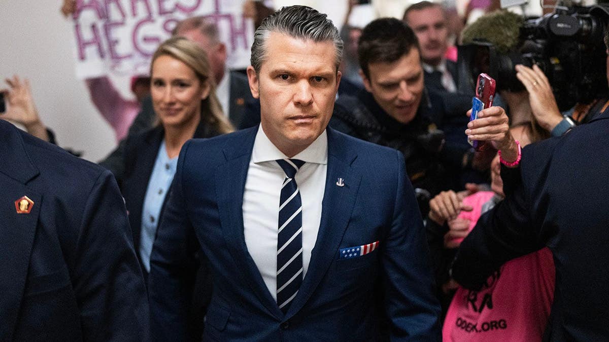 Defense Secretary Pete Hegseth and his wife Jennifer arriving at a congressional hearing