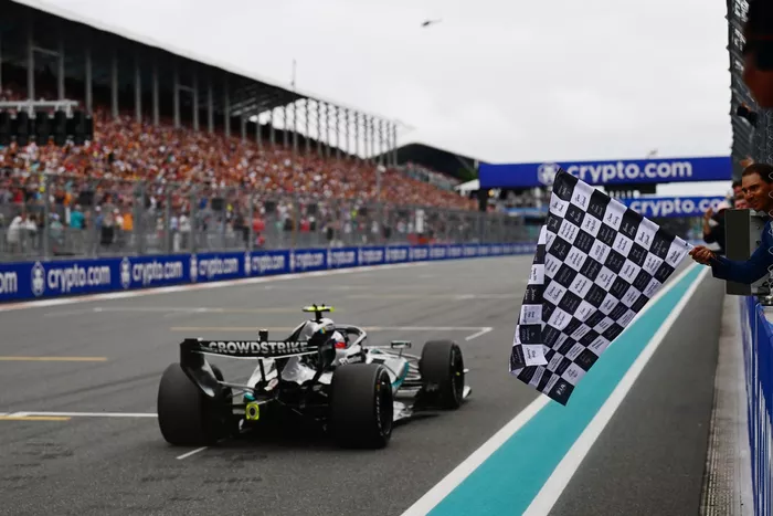 Rafael Nadal waves the chequered flag for Race winner Andrea Kimi Antonelli, Mercedes
