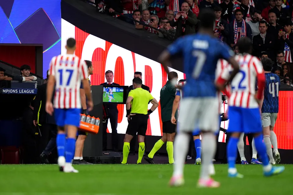 Referee Danny Makkelie checks the VAR screen in Atletico Madrid v Arsenal.