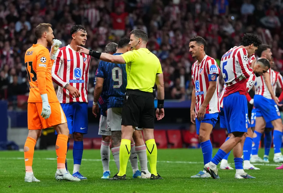 Referee Danny Makkelie reacts with David Hancko of Atletico de Madrid before overturning a penalty to Arsenal following a VAR review 