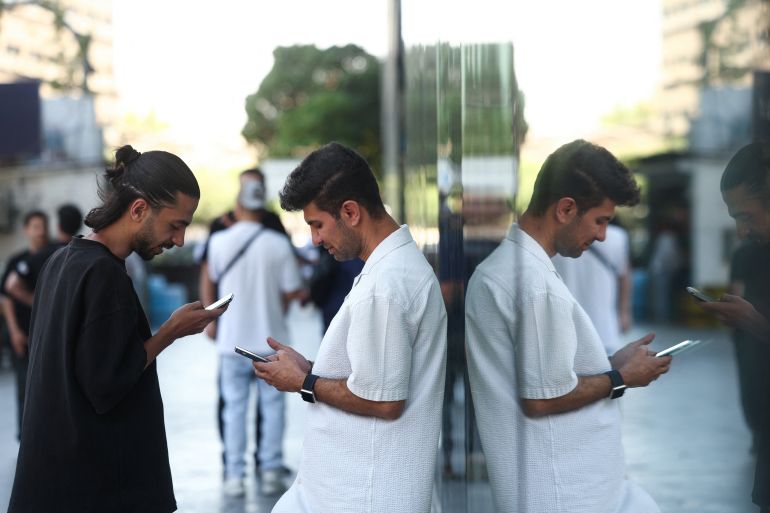 Iranian men use their phones, after a reported reopening of international internet access, in Tehran, Iran, May 27, 2026. Majid Asgaripour/WANA (West Asia News Agency) via REUTERS ATTENTION EDITORS - THIS PICTURE WAS PROVIDED BY A THIRD PARTY. ISRAEL OUT. NO COMMERCIAL OR EDITORIAL SALES IN ISRAEL. NO USE BBC PERSIAN. NO USE VOA PERSIAN. NO USE MANOTO. NO USE IRAN INTERNATIONAL. NO USE RADIO FARDA. DIGITAL: NO USE BBC PERSIAN. NO USE VOA PERSIAN. NO USE MANOTO. NO USE IRAN INTERNATIONAL. NO USE RADIO FARDA. NO USE ISRAEL.