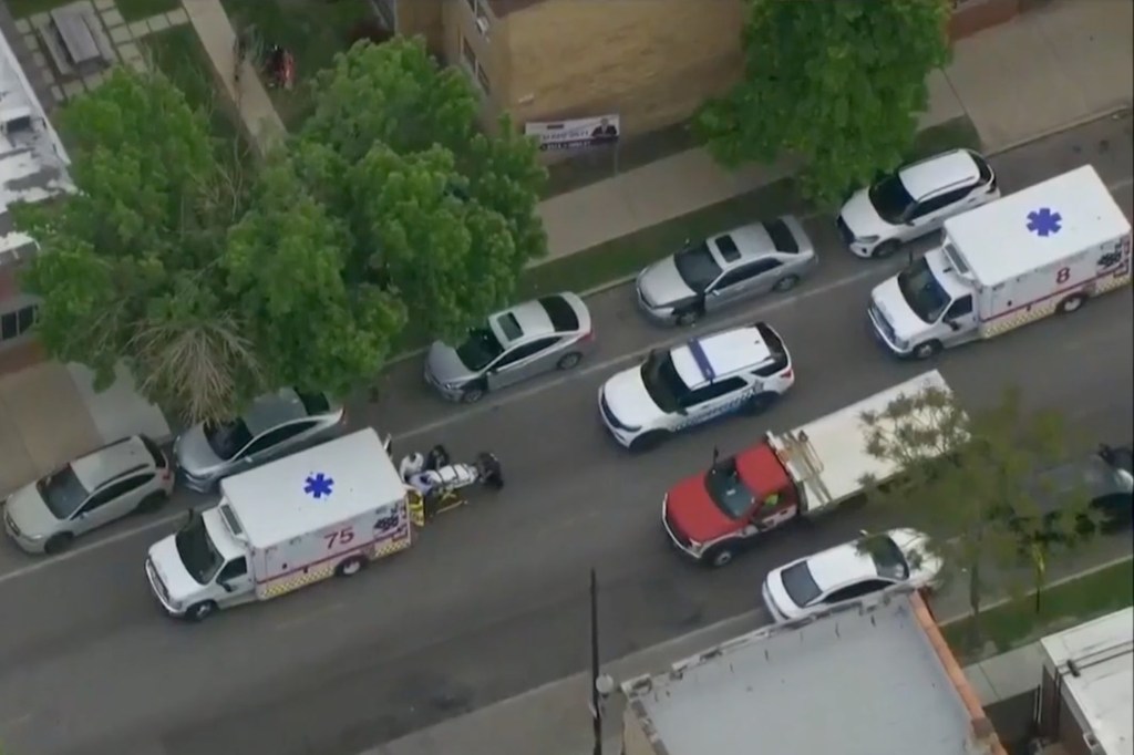 Aerial view of emergency vehicles and police cars on a residential street.