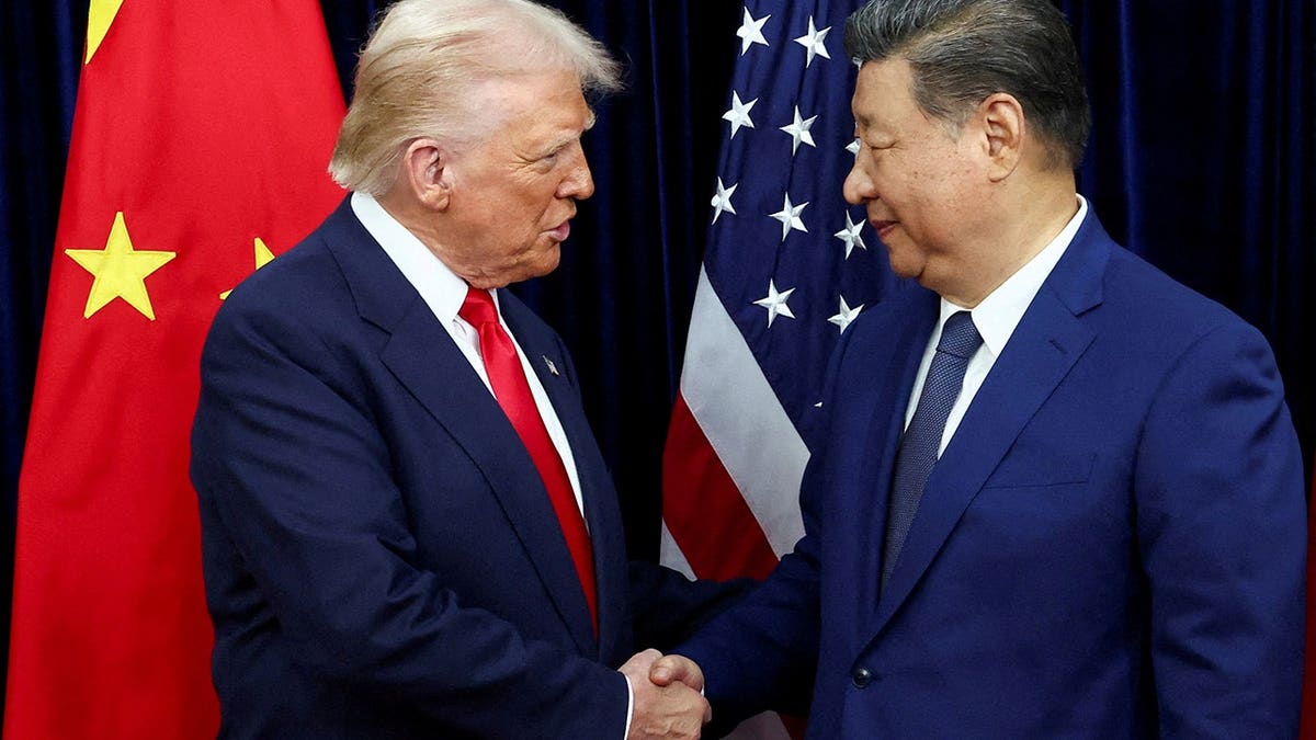U.S. President Donald Trump shaking hands with Chinese President Xi Jinping at Gimhae International Airport