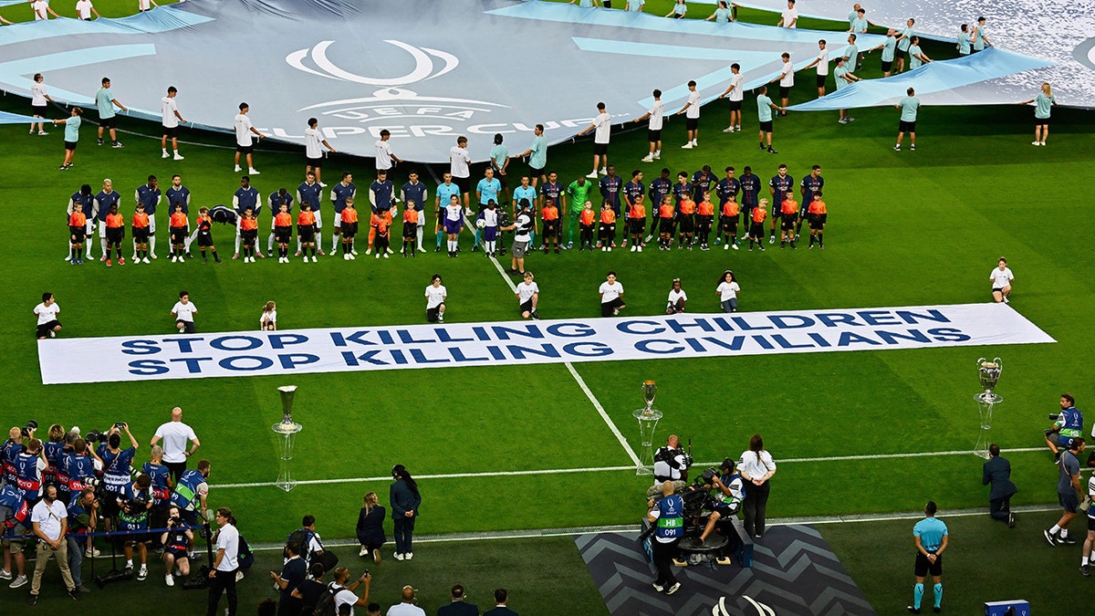 Paris Saint-Germain and Tottenham Hotspur players line up before a soccer match in Udine Italy