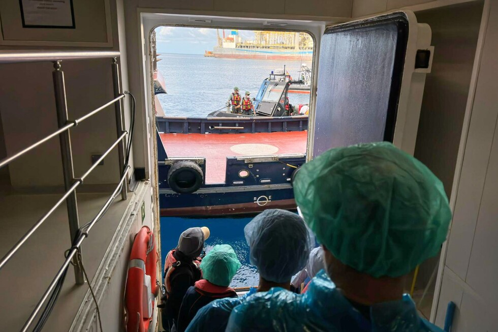 Passengers disembark from a hantavirus-stricken cruise ship, in photos