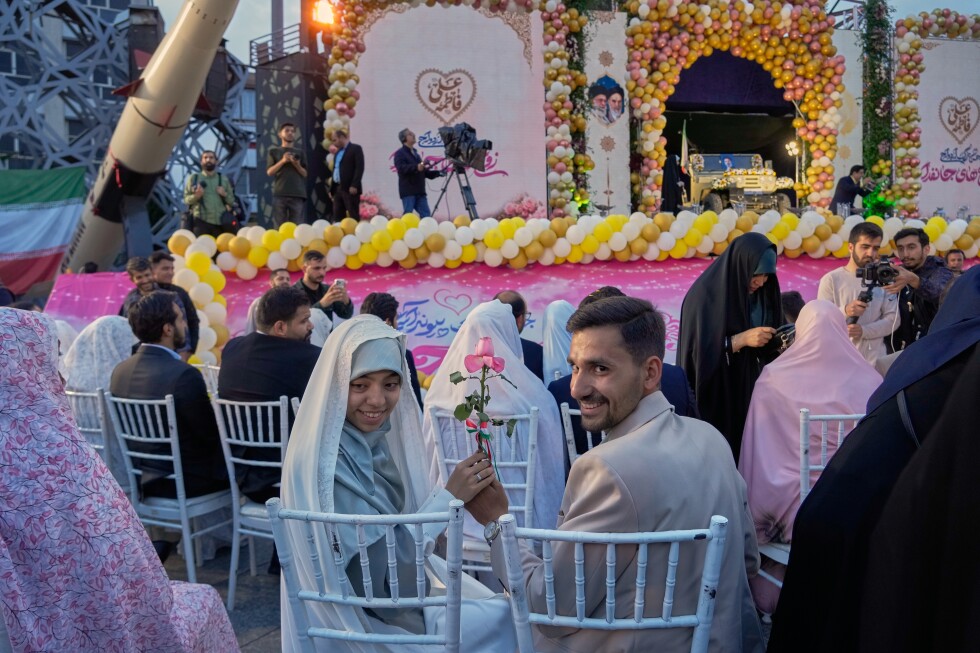 Photos of a mass wedding and a colorful missile at Tehran's 'Sacrifice for Iran' ceremony