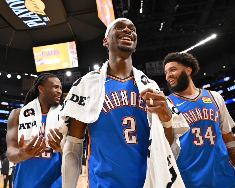 Kenrich Williams #34, Cason Wallace #22, and Shai Gilgeous-Alexander #2 of the Oklahoma City Thunder smile after the game against the Los Angeles Lakers during Round Two Game Three of the 2026 NBA Playoffs on May 9, 2026