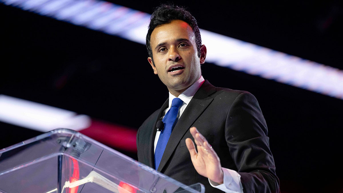 Vivek Ramaswamy speaking at a podium during Turning Point USA conference in Phoenix