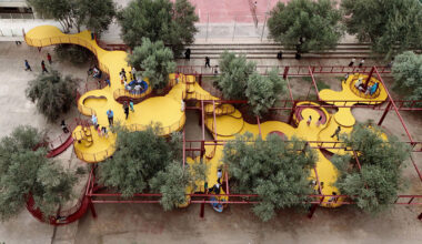 ZAV architects weaves yellow playground through olive orchard in iran