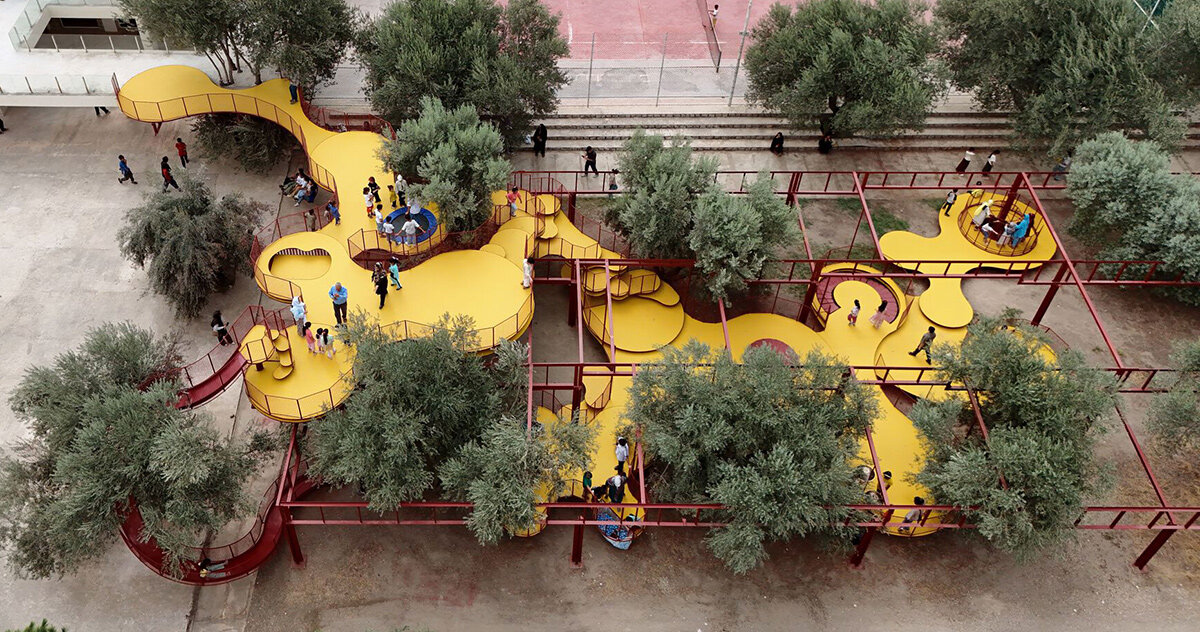 ZAV architects weaves yellow playground through olive orchard in iran