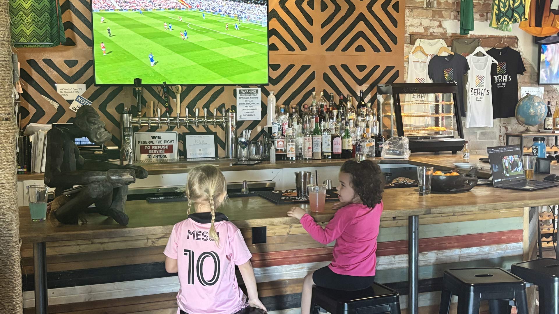 Kids watching soccer at Zerai's